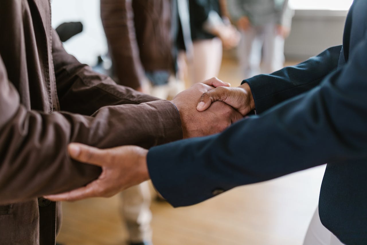 Home Close-up of two businesspeople shaking hands, symbolizing agreement and partnership.